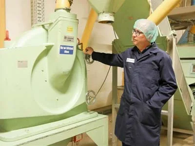 Mr. Weber, standing next to a Hosokawa Alpine mill